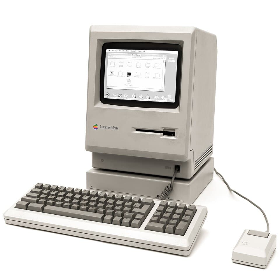 Illustration eines kompakten All-in-One-Computers mit grafischer Oberfläche und Maus.