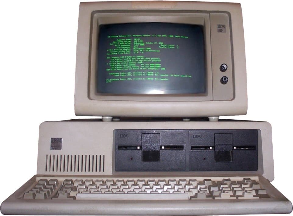 Illustration eines kantigen Desktop-PCs der frühen 1980er mit Tastatur und Monitor.